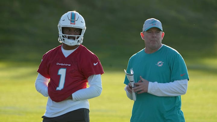 Oct 15, 2021; Ware, United Kingdom; Miami Dolphins quarterback Tua Tagovailoa (1) and co-offensive coordinator George Godsey during practice at Hanbury Marriott Manor and Country Club. Mandatory Credit: Kirby Lee-Imagn Images