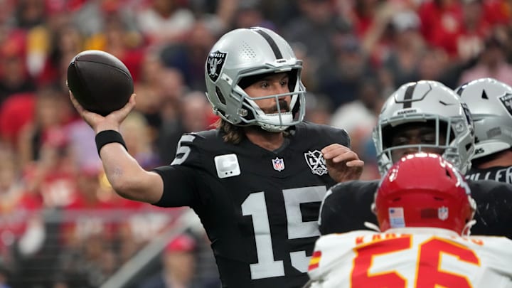 Oct 27, 2024; Paradise, Nevada, USA; Las Vegas Raiders quarterback Gardner Minshew (15) throws the ball against Kansas City Chiefs safety Chamarri Conner (27) in the first half at Allegiant Stadium. Mandatory Credit: Kirby Lee-Imagn Images