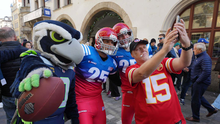 Nov 9, 2024; Munich, Germany; Seattle Seahawks mascot Blitz poses for selfie with a Kansas City Chiefs fan wearing No. 15 Patrick Mahomes jersey at the Seahawks team pub at the Hard Rock Cafe. Mandatory Credit: Kirby Lee-Imagn Images