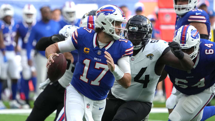 Oct 8, 2023; London United Kingdom, Buffalo Bills quarterback Josh Allen (17)] throws the ball under pressure from Jacksonville Jaguars defensive tackle Folorunso Fatukasi (94) during the first half of an NFL International Series game at Tottenham Hotspur Stadium. Mandatory Credit: Kirby Lee-USA TODAY Sports