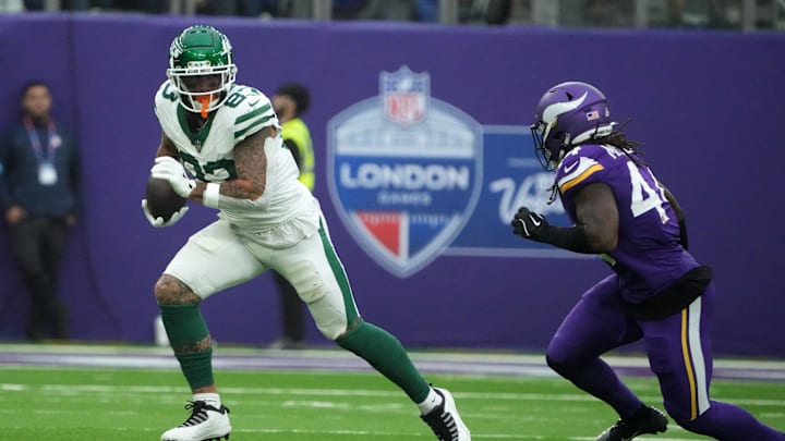 Oct 6, 2024; London, United Kingdom; New York Jets tight end Tyler Conklin (83) carries the ball against Minnesota Vikings safety Josh Metellus (44) in the second half at Tottenham Hotspur Stadium. Mandatory Credit: Kirby Lee-Imagn Images