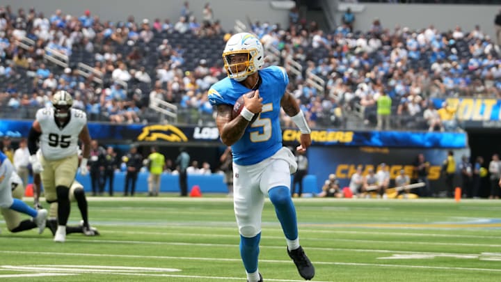 Aug 10, 2025; Inglewood, California, USA; Los Angeles Chargers quarterback Trey Lance (5) carries the ball against the New Orleans Saints in the first half at SoFi Stadium. Mandatory Credit: Kirby Lee-Imagn Images