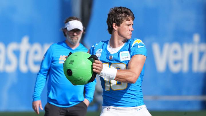 Jul 25, 2025; El Segundo, CA, USA; Los Angeles Chargers quarterback Justin Herbert (10) works out as quarterbacks coach Shane Day watches during training camp at The Bolt. Mandatory Credit: Kirby Lee-Imagn Images