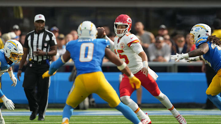 Sep 29, 2024; Inglewood, California, USA; Kansas City Chiefs quarterback Patrick Mahomes (15) throws the ball against Los Angeles Chargers defensive end Morgan Fox (56), linebacker Daiyan Henley (0) and linebacker Bud Dupree (48) in the second half at SoFi Stadium. Mandatory Credit: Kirby Lee-Imagn Images