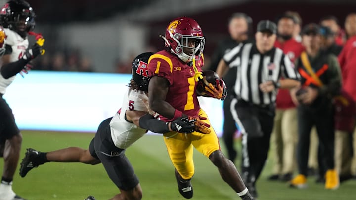 Oct 25, 2024; Los Angeles, California, USA;Southern California Trojans wide receiver Zachariah Branch (1) carries the ball against Rutgers Scarlet Knights defensive back Kaj Sanders (5) in the first half at United Airlines Field at Los Angeles Memorial Coliseum. Mandatory Credit: Kirby Lee-Imagn Images