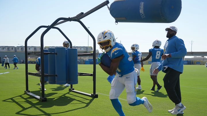 Aug 7, 2025; El Segundo, CA, USA; Los Angeles Chargers running back Raheim Sanders (35) interacts with running backs coach Kiel McDonald during training camp at The Bolt. Mandatory Credit: Kirby Lee-Imagn Images