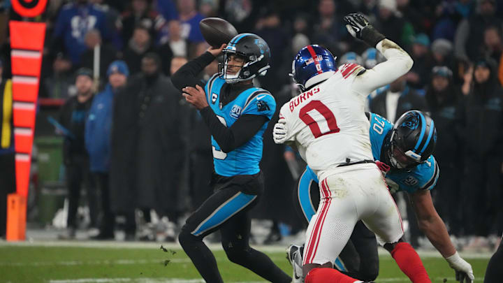 Nov 10, 2024; Munich, Germany; Carolina Panthers quarterback Bryce Young (9) throws the ball under pressure from New York Giants linebacker Brian Burns (0) in the second half during the 2024 NFL Munich Game at Allianz Arena. Nov 10, 2024; Munich, Germany; Carolina Panthers quarterback Bryce Young (9) throws the ball under pressure from New York Giants linebacker Brian Burns (0) in the second half during the 2024 NFL Munich Game at Allianz Arena.