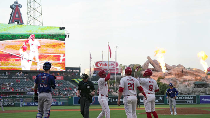 Jul 10, 2024; Anaheim, California, USA;  Los Angeles Angels center fielder Mickey Moniak (16) celebrates with shortstop Zach Neto (9) and catcher Matt Thaiss (21) after hitting a three-run home run in the second inning against Texas Rangers starting pitcher Michael Lorenzen (23) at Angel Stadium. Mandatory Credit: Kirby Lee-Imagn Images