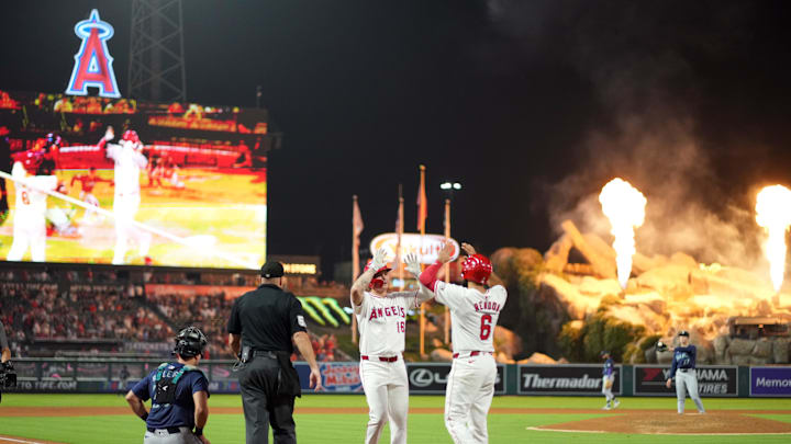Aug 31, 2024; Anaheim, California, USA; Los Angeles Angels center fielder Mickey Moniak (16) celebrates with third baseman Anthony Rendon (6) after hitting a two-run home run in the seventh inning as Seattle Mariners starting pitcher Bryan Woo (22) and catcher Cal Raleigh (29) watch at Angel Stadium. Mandatory Credit: Kirby Lee-Imagn Images
