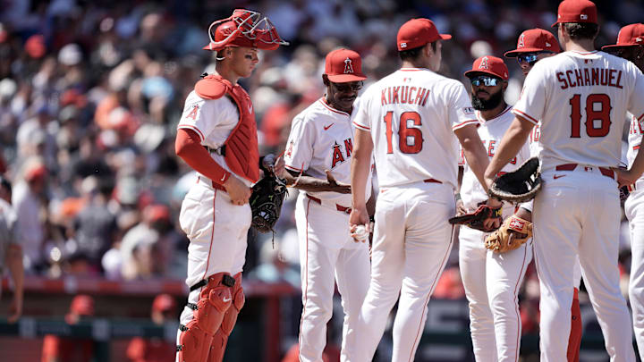 Apr 20, 2025; Anaheim, California, USA; Los Angeles Angels starting pitcher Yusei Kikuchi (16) is removed from the game by manager Ron Washington (37) as catcher Logan O'Hoppe (14) and first baseman Nolan Schanuel (18) watch in the sixth inning against the San Francisco Giants at Angel Stadium. Mandatory Credit: Kirby Lee-Imagn Images