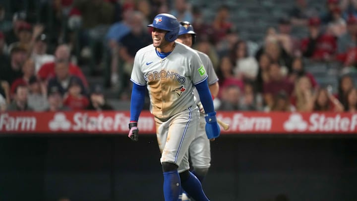 May 8, 2025; Anaheim, California, USA; Toronto Blue Jays designated hitter George Springer (4) celebrates after scoring on a throwing error in the sixth inning against the Los Angeles Angels at Angel Stadium. May 8, 2025; Anaheim, California, USA; Toronto Blue Jays designated hitter George Springer (4) celebrates after scoring on a throwing error in the sixth inning against the Los Angeles Angels at Angel Stadium.