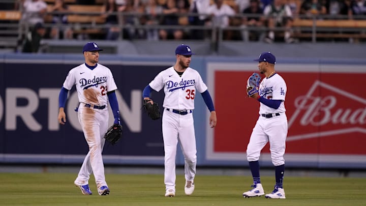 Sep 24, 2022; Los Angeles, California, USA; Los Angeles Dodgers left fielder Trayce Thompson (25), center fielder Cody Bellinger (35) and right fielder Mookie Betts (50) celebrate at the end of the game against the St. Louis Cardinals at Dodger Stadium. Mandatory Credit: Kirby Lee-Imagn Images