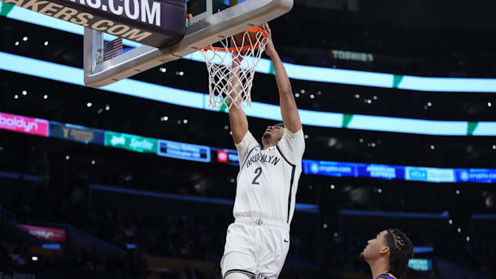 Jan 19, 2024; Los Angeles, California, USA; Brooklyn Nets forward Cameron Johnson (2) dunks the ball against Los Angeles Lakers guard Jalen Hood-Schifino (0) in the second half at Crypto.com Arena. Mandatory Credit: Kirby Lee-Imagn Images