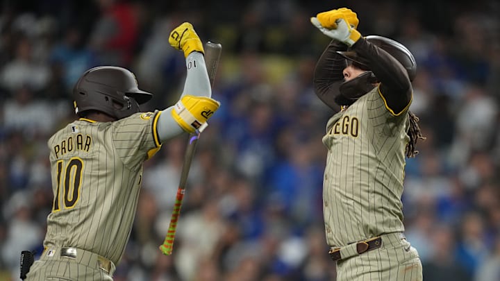Sep 25, 2024; Los Angeles, California, USA;  San Diego Padres right fielder Fernando Tatis Jr. (23) celebrates with left fielder Jurickson Profar (10) after hitting a home run in the fifth inning against the Los Angeles Dodgers at Dodger Stadium. Mandatory Credit: Kirby Lee-Imagn Images