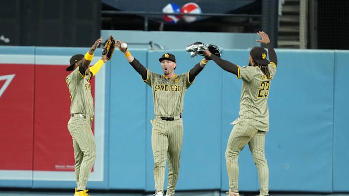 Apr 12, 2024; Los Angeles, California, USA; San Diego Padres left fielder Jurickson Profar (10), center fielder Jackson Merrill (3) and right fielder Fernando Tatis Jr. (23) celebrate after the game against the Los Angeles Dodgers at Dodger Stadium. Mandatory Credit: Kirby Lee-Imagn Images