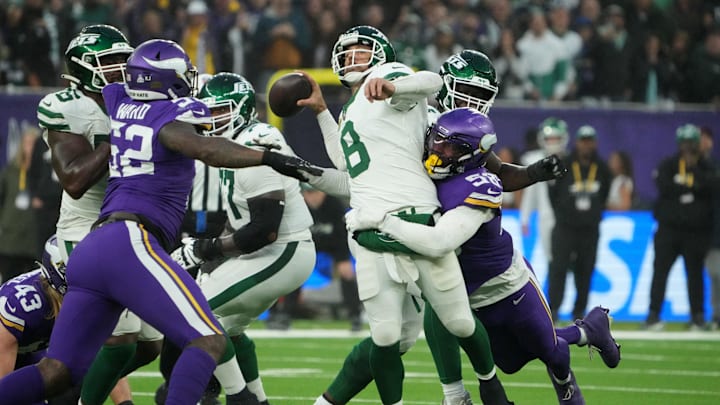 Oct 6, 2024; London, United Kingdom; New York Jets quarterback Aaron Rodgers (8) throws the ball under pressure from Minnesota Vikings linebacker Jonathan Greenard (58) in the fourth quarter at Tottenham Hotspur Stadium. Mandatory Credit: Kirby Lee-Imagn Images