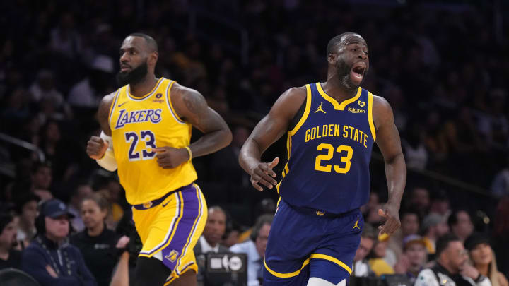 Apr 9, 2024; Los Angeles, California, USA; Golden State Warriors forward Draymond Green (right) and Los Angeles Lakers forward LeBron James react in the first half at Crypto.com Arena. 
