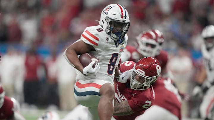 Dec 28, 2023; San Antonio, TX, USA; Arizona Wildcats running back DJ Williams (8) scores on a 19-yard touchdown run against the Oklahoma Sooners in the second half of the Alamo Bowl at Alamodome. Mandatory Credit: Kirby Lee-Imagn Images Dec 28, 2023; San Antonio, TX, USA; Arizona Wildcats running back DJ Williams (8) scores on a 19-yard touchdown run against the Oklahoma Sooners in the second half of the Alamo Bowl at Alamodome. Mandatory Credit: Kirby Lee-Imagn Images