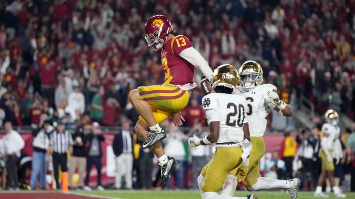 Nov 26, 2022; Los Angeles, California, USA; Southern California Trojans quarterback Caleb Williams (13) celebrates after rushing for a touchdown against the Notre Dame Fighting Irish in the second half at United Airlines Field at Los Angeles Memorial Coliseum. Mandatory Credit: Kirby Lee-USA TODAY Sports Nov 26, 2022; Los Angeles, California, USA; Southern California Trojans quarterback Caleb Williams (13) celebrates after rushing for a touchdown against the Notre Dame Fighting Irish in the second half at United Airlines Field at Los Angeles Memorial Coliseum. Mandatory Credit: Kirby Lee-USA TODAY Sports