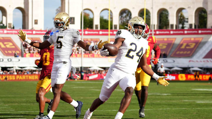 Nov 30, 2024; Los Angeles, California, USA; Notre Dame Fighting Irish running back Jadarian Price (24) scores on a 36-yard touchdown run against the Southern California Trojans in the second half at United Airlines Field at Los Angeles Memorial Coliseum. Mandatory Credit: Kirby Lee-Imagn Images