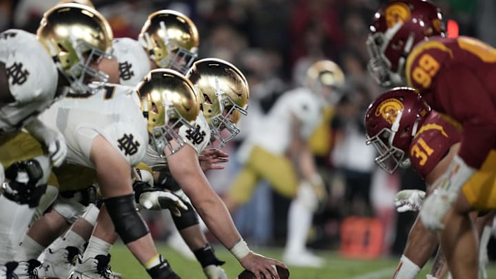 Nov 26, 2022; Los Angeles, California, USA; A general overall view of helmets at the line of scrimmage as Notre Dame Fighting Irish offensive lineman Zeke Correll (52) snaps the ball against the Southern California Trojans in the second half at United Airlines Field at Los Angeles Memorial Coliseum. Nov 26, 2022; Los Angeles, California, USA; A general overall view of helmets at the line of scrimmage as Notre Dame Fighting Irish offensive lineman Zeke Correll (52) snaps the ball against the Southern California Trojans in the second half at United Airlines Field at Los Angeles Memorial Coliseum.