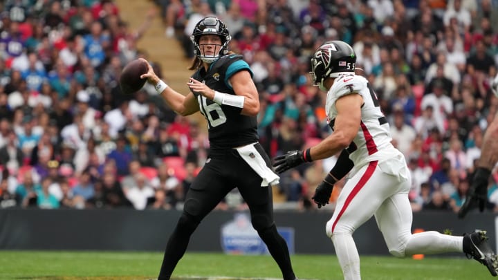 Oct 1, 2023; London, United Kingdom; Jacksonville Jaguars quarterback Trevor Lawrence (16) throws the ball under pressure from Atlanta Falcons linebacker Kaden Elliss (55) in the first half during an NFL International Series game at Wembley Stadium. Mandatory Credit: Kirby Lee-USA TODAY Sports