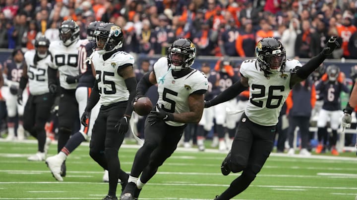 Oct 13, 2024; London, United Kingdom; Jacksonville Jaguars safety Andre Cisco (5) and safety Antonio Johnson (26) celebrate after an interception against the Chicago Bears in the first half during an NFL International Series game at Tottenham Hotspur Stadium. Mandatory Credit: Kirby Lee-Imagn Images