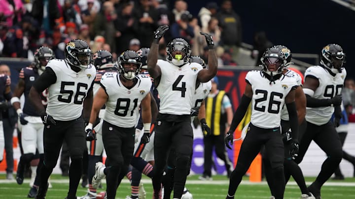 Oct 13, 2024; London, United Kingdom; Jacksonville Jaguars linebacker Yasir Abdullah (56), tight end Josiah Deguara (81), running back Tank Bigsby (4) and safety Antonio Johnson (26) celebrate against the Chicago Bears in the first half during an NFL International Series game at Tottenham Hotspur Stadium. Mandatory Credit: Kirby Lee-Imagn Images