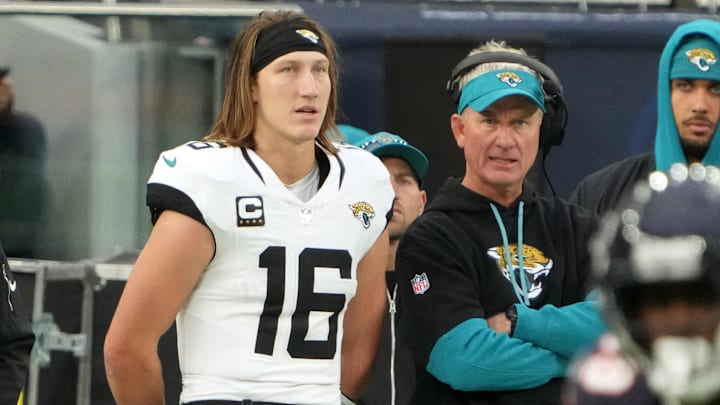 Oct 13, 2024; London, United Kingdom; Jacksonville Jaguars quarterback Trevor Lawrence (16) and quarterbacks coach Mike McCoy watch from the sidelines in the second half during an NFL International Series game Chicago Bears atTottenham Hotspur Stadium. Mandatory Credit: Kirby Lee-Imagn Images