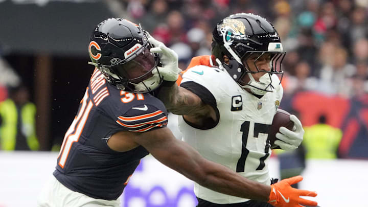 Oct 13, 2024; London, United Kingdom; Jacksonville Jaguars tight end Evan Engram (17) carries the ball against Chicago Bears safety Kevin Byard III (31) in the second half during an NFL International Series game at Tottenham Hotspur Stadium. Mandatory Credit: Kirby Lee-Imagn Images