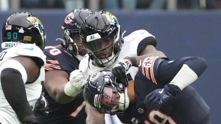 Oct 13, 2024; London, United Kingdom; Chicago Bears quarterback Caleb Williams (18) is tackled by Jacksonville Jaguars defensive end Josh Hines-Allen (41) in the second half during an NFL International Series game at Tottenham Hotspur Stadium. Mandatory Credit: Kirby Lee-Imagn Images