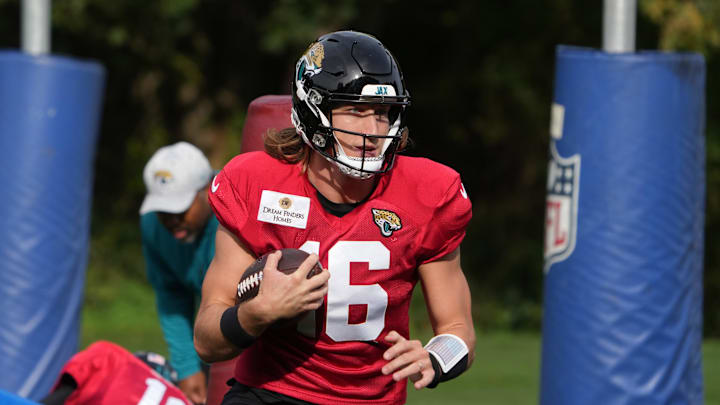 Oct 17, 2024; Watford, United Kingdom; Jacksonville Jaguars quarterback Trevor Lawrence (16) carries the ball during practice at The Grove. Mandatory Credit: Kirby Lee-Imagn Images