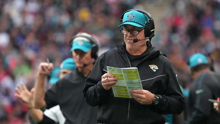 Oct 20, 2024; London, United Kingdom; Jacksonville Jaguars coach Doug Pederson (right) and quarterbacks coach Mike McCoy watch from the sidelines against the New England Patriots in the first half of an NFL International Series game at Wembley Stadium. Mandatory Credit: Kirby Lee-Imagn Images