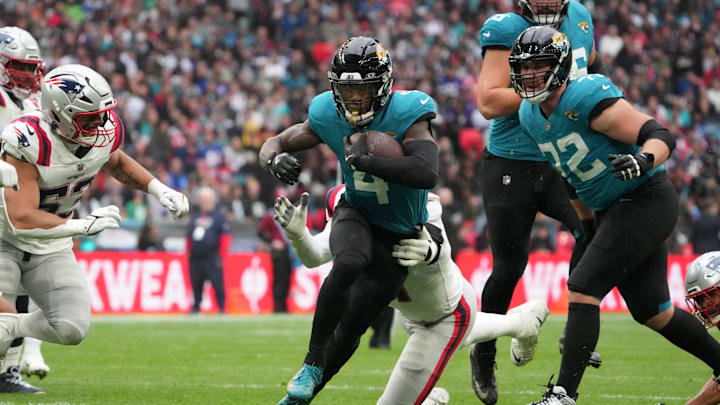Oct 20, 2024; London, United Kingdom; Jacksonville Jaguars running back Tank Bigsby (4) carries the ball against the New England Patriots in the first half of an NFL International Series game at Wembley Stadium. Mandatory Credit: Kirby Lee-Imagn Images