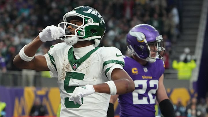 Oct 6, 2024; London, United Kingdom; New York Jets wide receiver Garrett Wilson (5) celebrates after scoring on a 1-yard touchdown reception against the New York Jets in the fourth quarter at Tottenham Hotspur Stadium. Mandatory Credit: Kirby Lee-Imagn Images