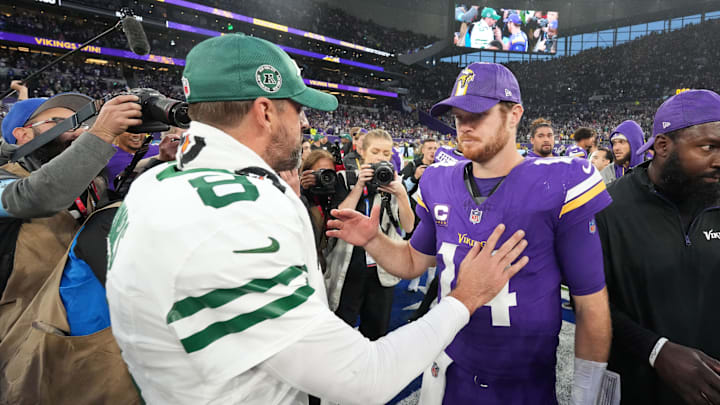 Oct 6, 2024; London, United Kingdom; New York Jets quarterback Aaron Rodgers (8) shakes hands with Minnesota Vikings quarterback Sam Darnold (14) after the game at Tottenham Hotspur Stadium. Mandatory Credit: Kirby Lee-Imagn Images
