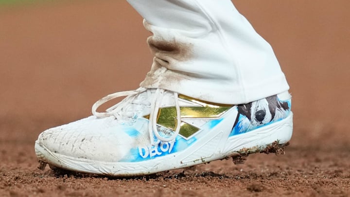 Aug 21, 2024; Los Angeles, California, USA; A detailed view of the New Balance cleats worn by Los Angeles Dodgers designated hitter Shohei Ohtani (17) with image of his dog Decoy during the game against the Seattle Mariners at Dodger Stadium. Mandatory Credit: Kirby Lee-Imagn Images
