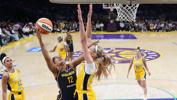 Aug 5, 2025; Los Angeles, California, USA; Indiana Fever forward Damiris Dantas (12) shoots the ball against LA Sparks forward Cameron Brink (22) in the second half at Crypto.com Arena. Mandatory Credit: Kirby Lee-Imagn Images