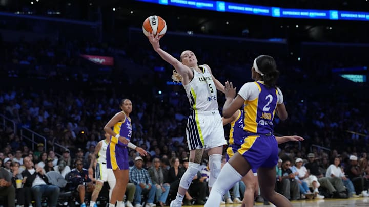 Aug 20, 2025; Los Angeles, California, USA;Dallas Wings guard Paige Bueckers (5) shoots the ball against LA Sparks forward Rickea Jackson (2) in the first half at Crypto.com Arena. Mandatory Credit: Kirby Lee-Imagn Images