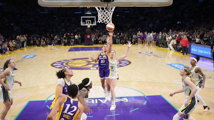 Aug 20, 2025; Los Angeles, California, USA; LA Sparks guard Kelsey Plum (10) scores with no time remaining against Dallas Wings center Luisa Geiselsoder (18) for the game-winning basket at Crypto.com Arena. Mandatory Credit: Kirby Lee-Imagn Images