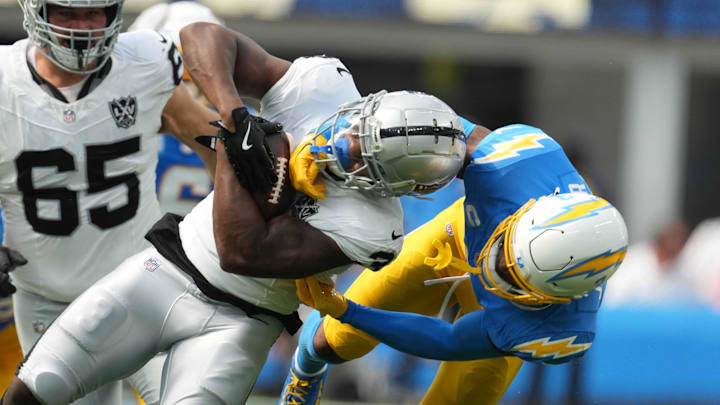 Sep 8, 2024; Inglewood, California, USA; Las Vegas Raiders running back Zamir White (left) is tackled by Los Angeles Chargers safety Derwin James Jr (3) in the second half at SoFi Stadium. Mandatory Credit: Kirby Lee-Imagn Images