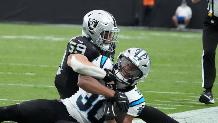 Sep 22, 2024; Paradise, Nevada, USA; Carolina Panthers running back Chuba Hubbard (30) is tackled by Las Vegas Raiders linebacker Luke Masterson (59) in the second half at Allegiant Stadium. Mandatory Credit: Kirby Lee-Imagn Images