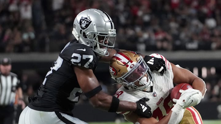 Aug 23, 2024; Paradise, Nevada, USA;  San Francisco 49ers running back Isaac Guerendo (49) is tackled by Las Vegas Raiders cornerback Sam Webb (27) on kickoff return against the Las Vegas Raiders in the first half at Allegiant Stadium. Mandatory Credit: Kirby Lee-Imagn Images
