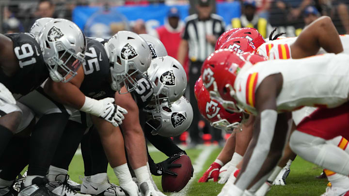 Oct 27, 2024; Paradise, Nevada, USA; Helmets at the line of scrimmage as Las Vegas Raiders long snapper Jacob Bobenmoyer (50) snaps the ball against the Kansas City Chiefs in the first half at Allegiant Stadium. Mandatory Credit: Kirby Lee-Imagn Images