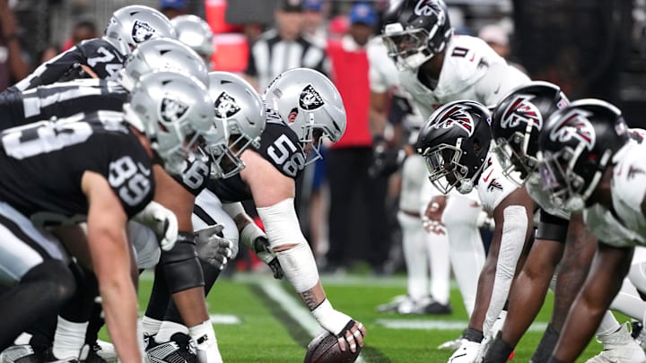 Dec 16, 2024; Paradise, Nevada, USA; Helmets at the line of scrimmage as Las Vegas Raiders guard Jackson Powers-Johnson (58) snaps the ball against the Atlanta Falcons in the first half at Allegiant Stadium. Mandatory Credit: Kirby Lee-Imagn Images Dec 16, 2024; Paradise, Nevada, USA; Helmets at the line of scrimmage as Las Vegas Raiders guard Jackson Powers-Johnson (58) snaps the ball against the Atlanta Falcons in the first half at Allegiant Stadium. Mandatory Credit: Kirby Lee-Imagn Images