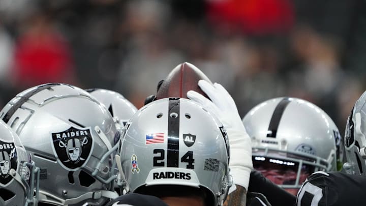 Nov 26, 2023; Paradise, Nevada, USA; Las Vegas Raiders defensive backs hold a football in a huddle against the Kansas City Chiefs Allegiant Stadium. Mandatory Credit: Kirby Lee-Imagn Images
