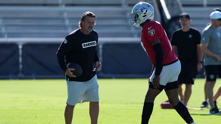 Jul 24, 2025; Henderson, NV, USA; Las Vegas Raiders quarterback Geno Smith (7) with quarterbacks coach Greg Olson during training camp at the Intermountain Healthcare Performance Center. Mandatory Credit: Kirby Lee-Imagn Images