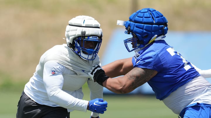 May 21, 2024, Thousand Oaks, California, USA; Los Angeles Rams defensive end Jared Verse (8) and offensive tackle Alaric Jackson (77) wear Guardian helmet caps during organized team activities at Cal Lutheran University. Mandatory Credit: Kirby Lee-USA TODAY Sports