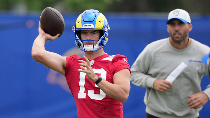 Jun 3, 2025; Woodland Hills, CA, USA; Los Angeles Rams quarterback Stetson Bennett (13) throws the ball as quarterbacks coach Dave Ragone watches during organized team activities at Rams Practice Facility. Mandatory Credit: Kirby Lee-Imagn Images