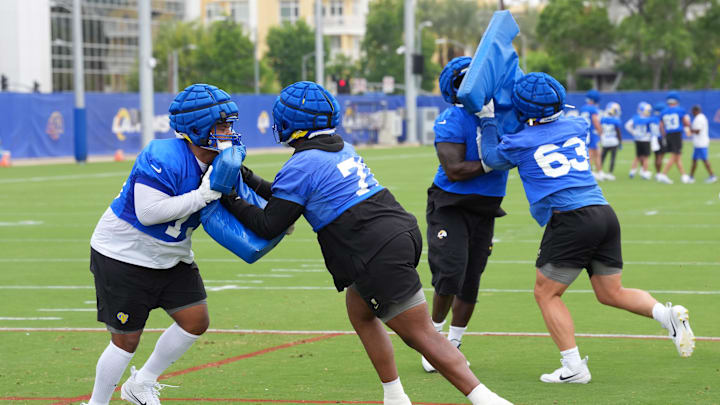 May 28, 2025; Woodland Hills, CA, USA; Los Angeles Rams offensive linemen (from left) Steve Avila (73),  Warren McClendon Jr.  (71), Kevin Dotson (69) and Dylan McMahon (63) participate in drills during organized team activities at Rams Practice Facility. Mandatory Credit: Kirby Lee-Imagn Images